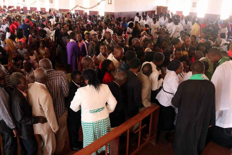 Padre Lourenco being greeted at a service