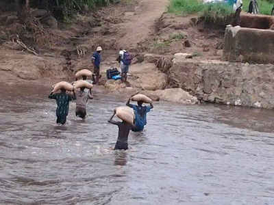 Men with sacks fording river