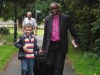 Bishop Dinis and a helper