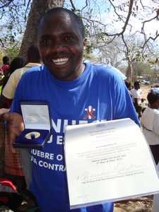 Showing the certificate and Medal