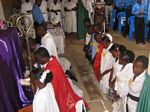 Bishop André praying with the confimration candidates