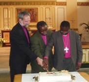 Bishops Dinis, Mark and Andre cut the cake
